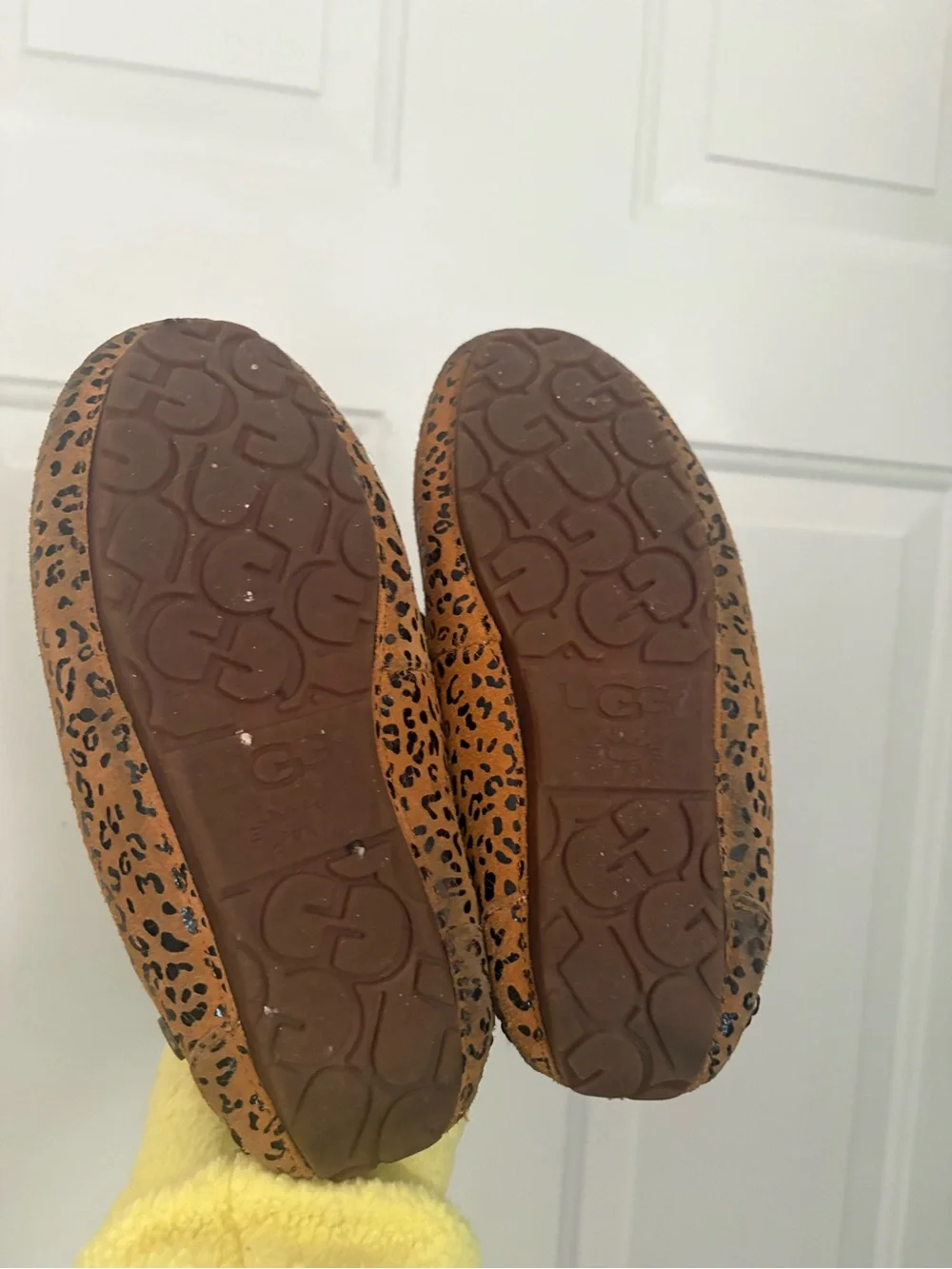UGG women’s Leopard Print Faux-Fur Lined Slip-Ons in Brown and Black